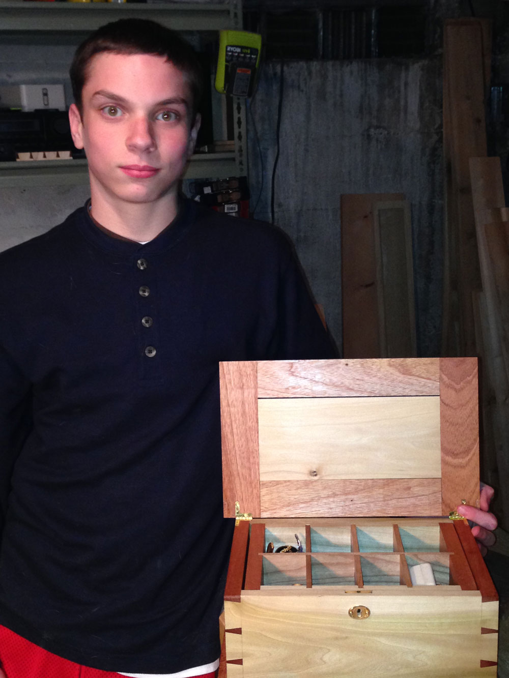 Danny with a jewelry box he made for my mother. It is made out of poplar, African mahogany and cherry. It is dovetailed at the corners and has a tray that lifts out to allow for more storage. The tray is dovetailed at the corners with houndstooth dovetails.
