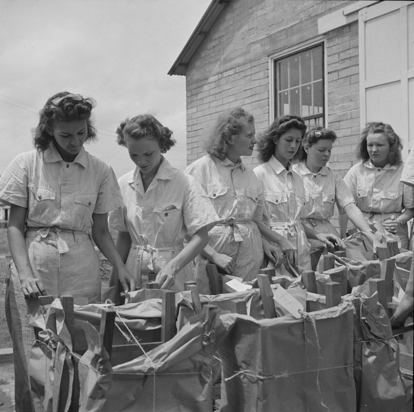 National Youth Administration girls with chairs they made ready for shipping, 1943.