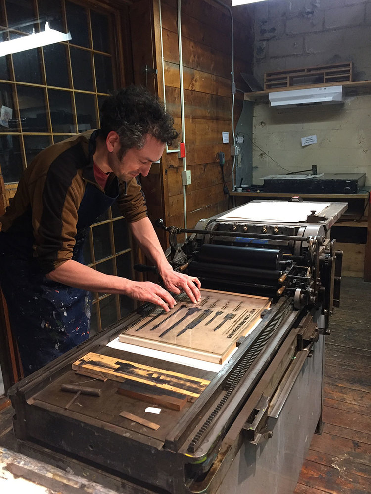 Abe getting ready to print using the Vandercook press at The Putney School.