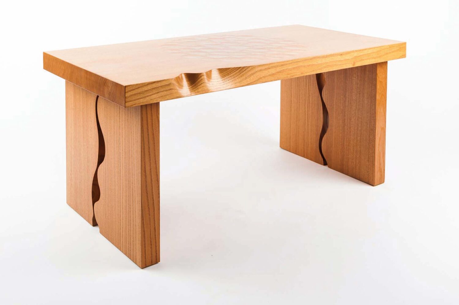 A table by David Savage wiht one live edge and subtle scallops on top