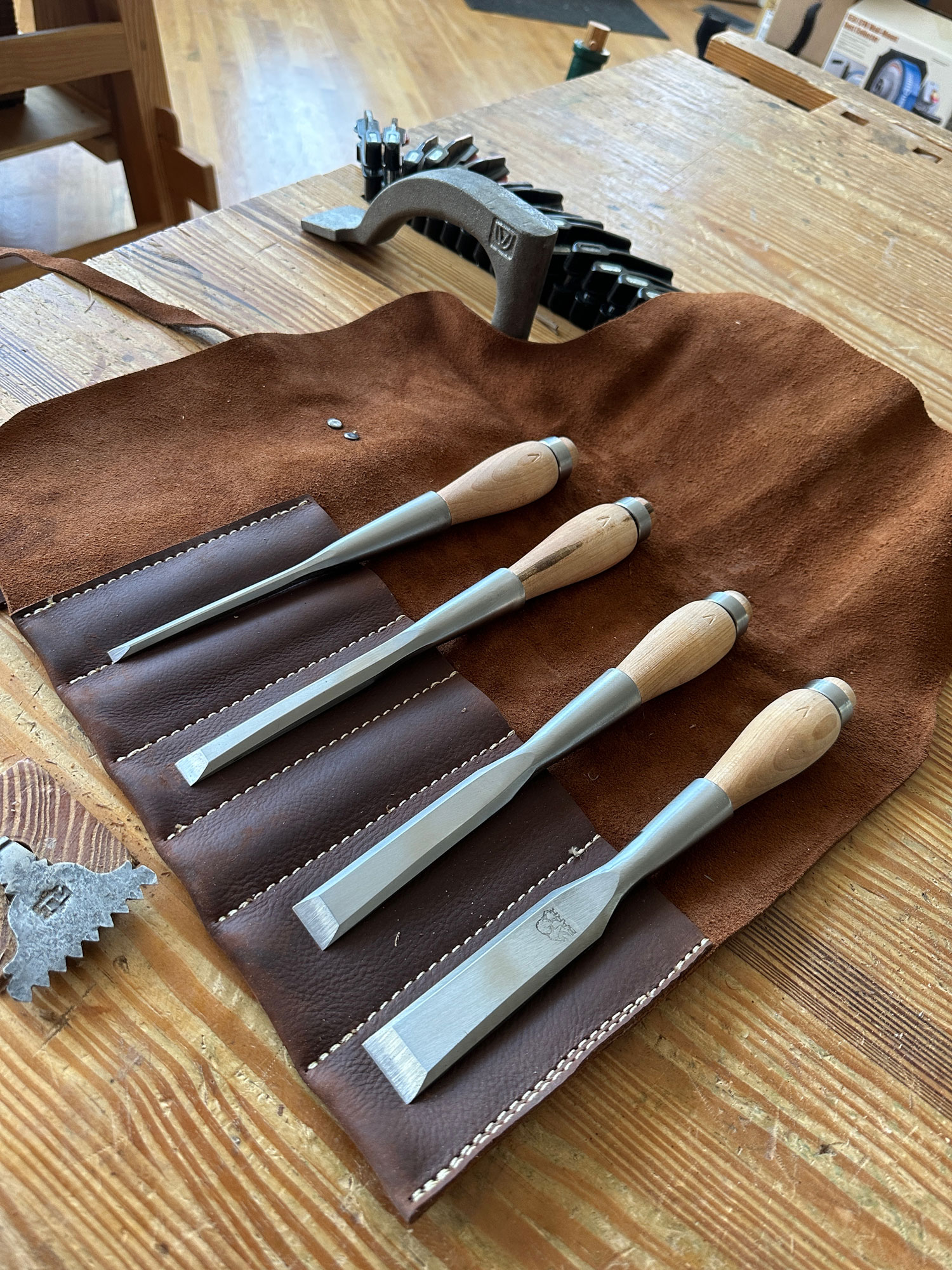 Old and well used wood carving chisels, on a old workbench. Stock Photo